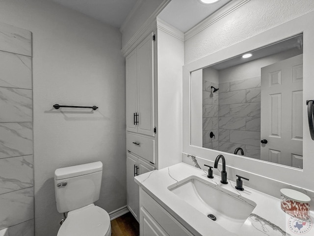 bathroom featuring vanity, toilet, hardwood / wood-style floors, and tiled shower