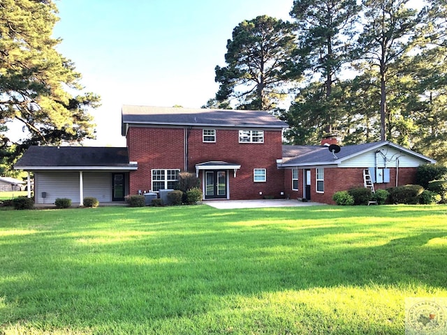 rear view of property with a patio area and a yard