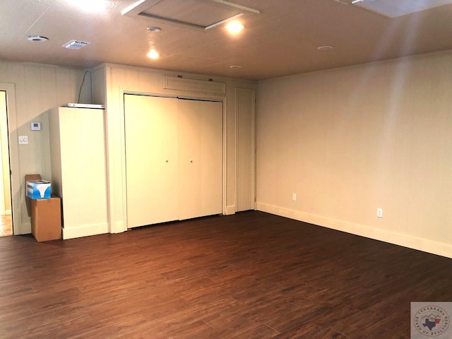 unfurnished bedroom with dark hardwood / wood-style flooring