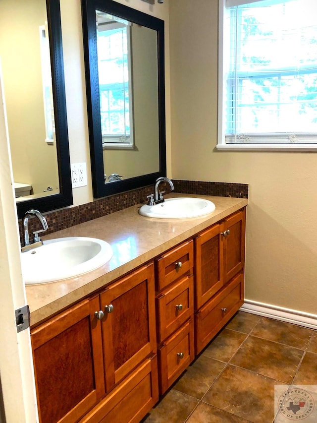 bathroom featuring vanity and tasteful backsplash