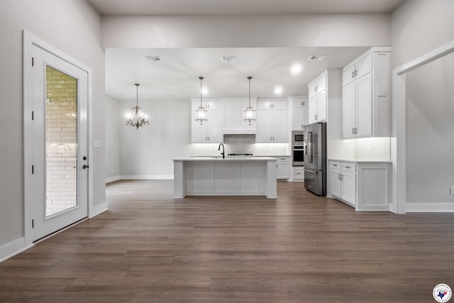 8409 Mandarin Cv, Texarkana, TX 75503 - kitchen featuring appliances with stainless steel finishes, decorative backsplash, white cabinetry, a sink, and recessed lighting