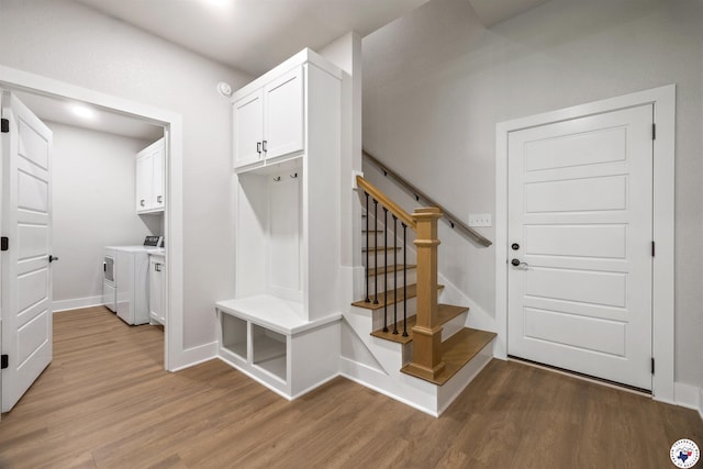 8409 Mandarin Cv, Texarkana, TX 75503 - mudroom featuring washer and dryer, light wood-type flooring, and baseboards