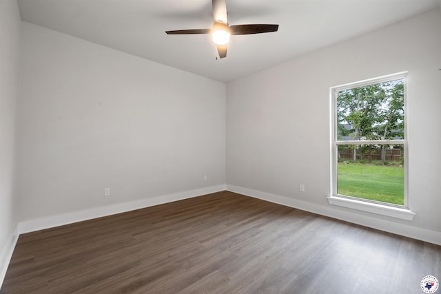 8409 Mandarin Cv, Texarkana, TX 75503 - unfurnished room with dark wood-style flooring, ceiling fan, and baseboards