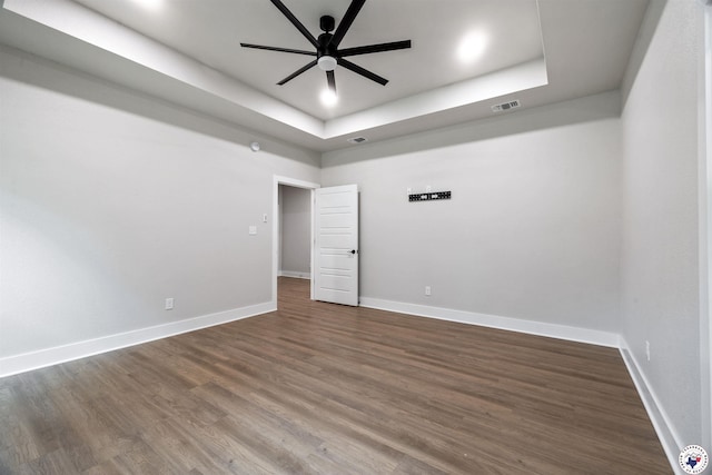 8409 Mandarin Cv, Texarkana, TX 75503 - spare room with a raised ceiling, a ceiling fan, dark wood finished floors, and baseboards