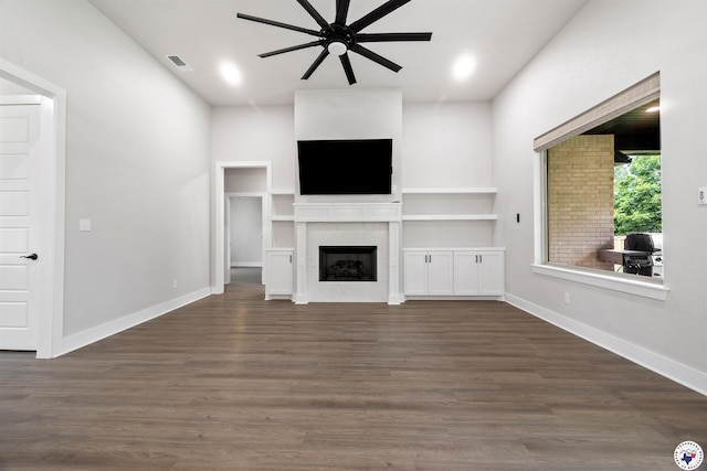 8409 Mandarin Cv, Texarkana, TX 75503 - unfurnished living room with ceiling fan, a fireplace, dark wood-style floors, and baseboards