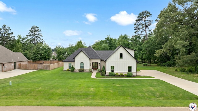 8409 Mandarin Cv, Texarkana, TX 75503 - french country inspired facade with board and batten siding, driveway, view of wooded area, and roof with shingles