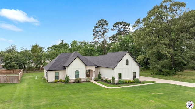 8409 Mandarin Cv, Texarkana, TX 75503 - french country style house with board and batten siding, a front lawn, roof with shingles, and view of scattered trees
