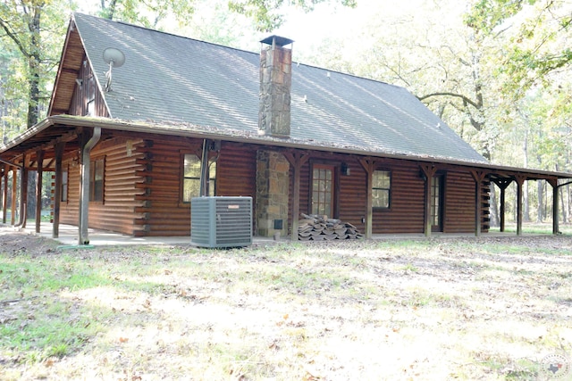 back of property featuring central AC