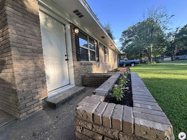 3706 Greenwood St, Texarkana, AR 71854 - view of exterior entry with a lawn and brick siding