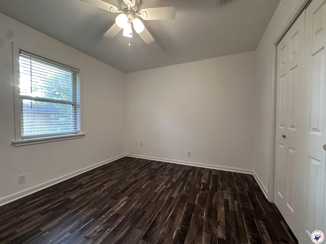 3706 Greenwood St, Texarkana, AR 71854 - unfurnished bedroom with dark wood-style flooring, baseboards, a closet, and a ceiling fan