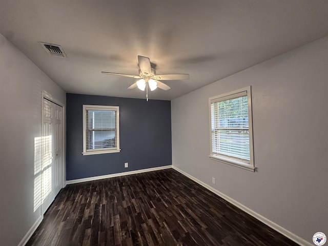 3706 Greenwood St, Texarkana, AR 71854 - unfurnished bedroom featuring dark wood finished floors, baseboards, a ceiling fan, and a closet