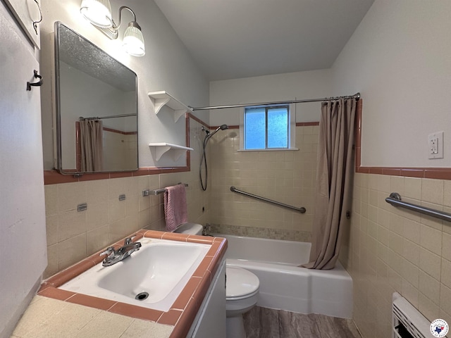 3706 Greenwood St, Texarkana, AR 71854 - full bath with tile walls, toilet, shower / bathtub combination with curtain, vanity, and wood finished floors