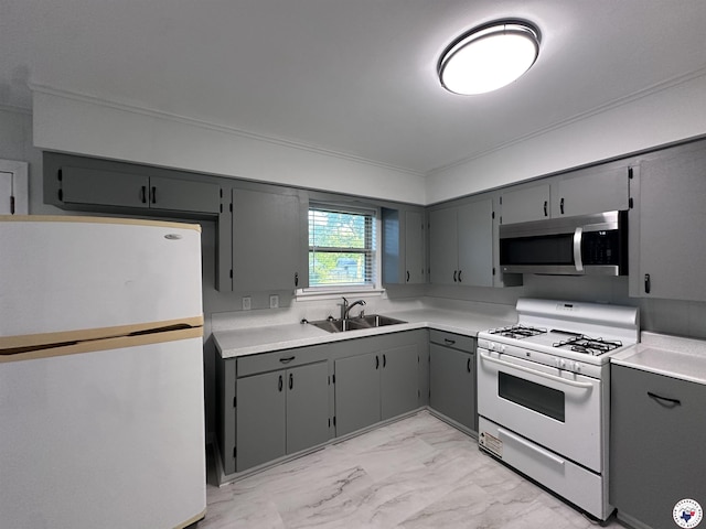 3706 Greenwood St, Texarkana, AR 71854 - kitchen with freestanding refrigerator, stainless steel microwave, white gas range, a sink, and gray cabinetry