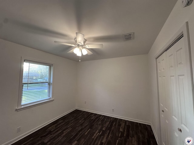 3706 Greenwood St, Texarkana, AR 71854 - unfurnished bedroom featuring dark wood-style floors, a closet, baseboards, and a ceiling fan