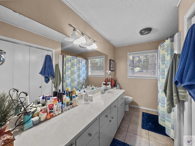 full bath featuring curtained shower, toilet, vanity, a textured ceiling, and tile patterned floors