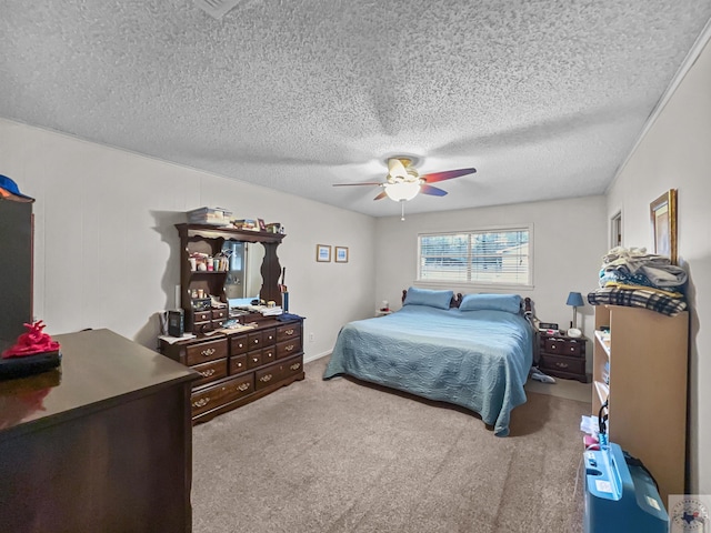 carpeted bedroom featuring ceiling fan and a textured ceiling