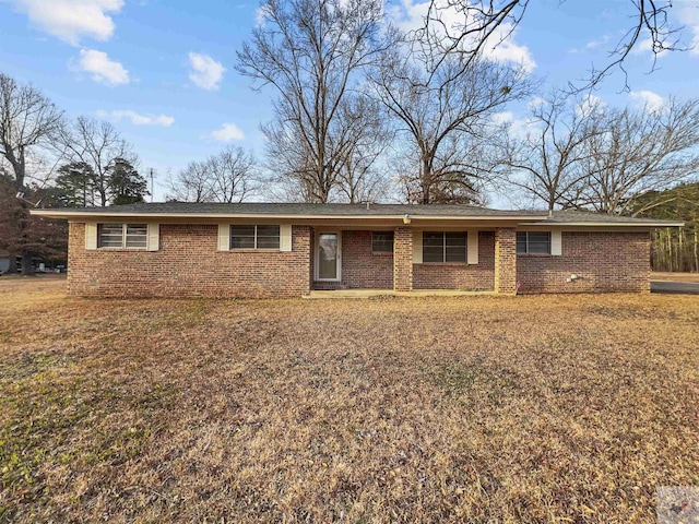 ranch-style house with a front yard and brick siding