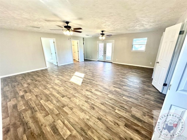 spare room featuring wood-type flooring, a textured ceiling, and french doors