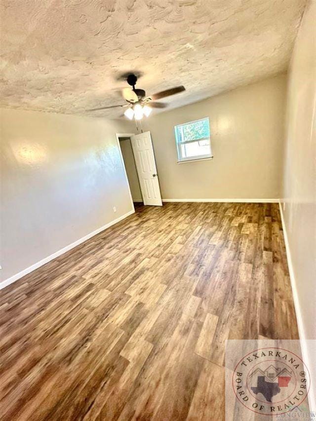 unfurnished room featuring hardwood / wood-style flooring, a textured ceiling, and ceiling fan