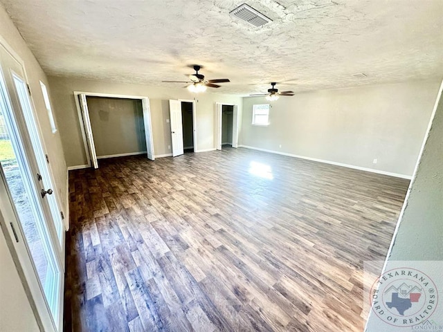 unfurnished bedroom with hardwood / wood-style flooring, a textured ceiling, and ceiling fan