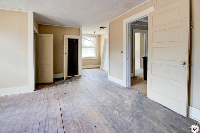 2101 Hazel St, Texarkana, TX 75501 - spare room featuring hardwood / wood-style flooring, a textured ceiling, and ornamental molding