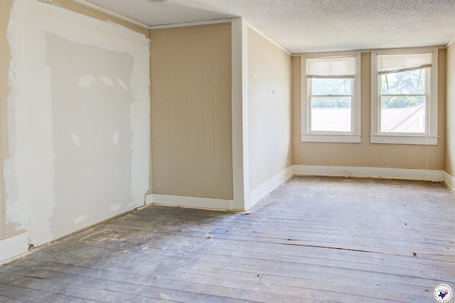 2101 Hazel St, Texarkana, TX 75501 - unfurnished room with a textured ceiling, ornamental molding, and wood finished floors