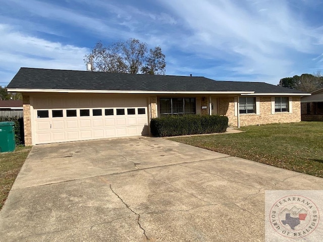 ranch-style home featuring a garage and a front lawn