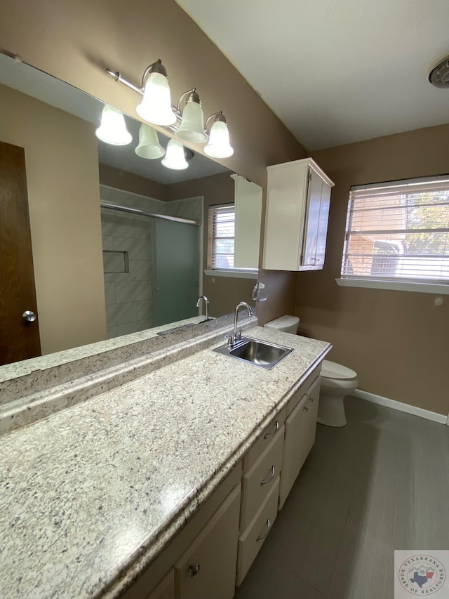 bathroom featuring a chandelier, toilet, an enclosed shower, and vanity