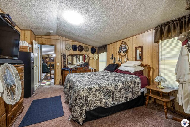 179 Fm 2791, Atlanta, TX 75551 - carpeted bedroom featuring vaulted ceiling, wood walls, and a textured ceiling