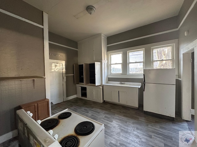 kitchen featuring dark hardwood / wood-style flooring, sink, white cabinets, and white appliances