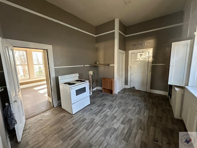 kitchen with white cabinetry, dark wood-type flooring, and white range with electric stovetop