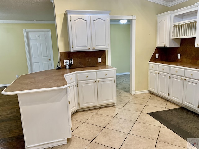 kitchen featuring ornamental molding and white cabinets