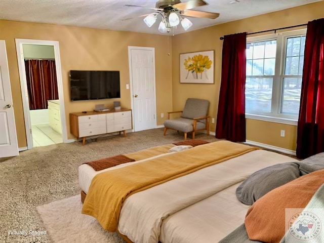 bedroom featuring ceiling fan, carpet flooring, baseboards, and connected bathroom