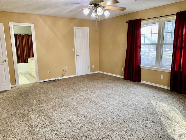 carpeted spare room with ceiling fan and a textured ceiling