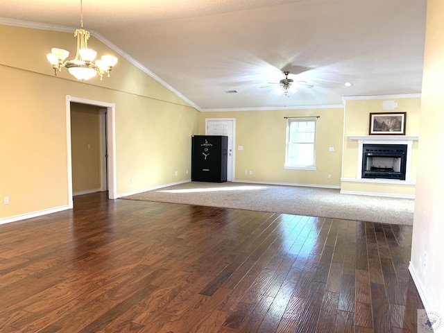 unfurnished living room featuring crown molding, dark hardwood / wood-style flooring, ceiling fan with notable chandelier, and vaulted ceiling