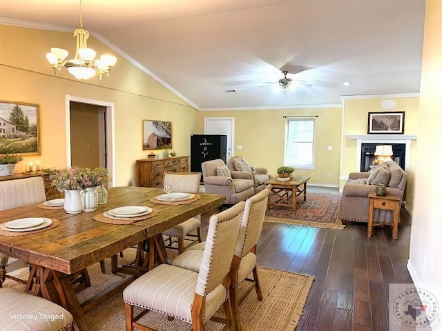 dining room with dark wood-style flooring, lofted ceiling, and ornamental molding