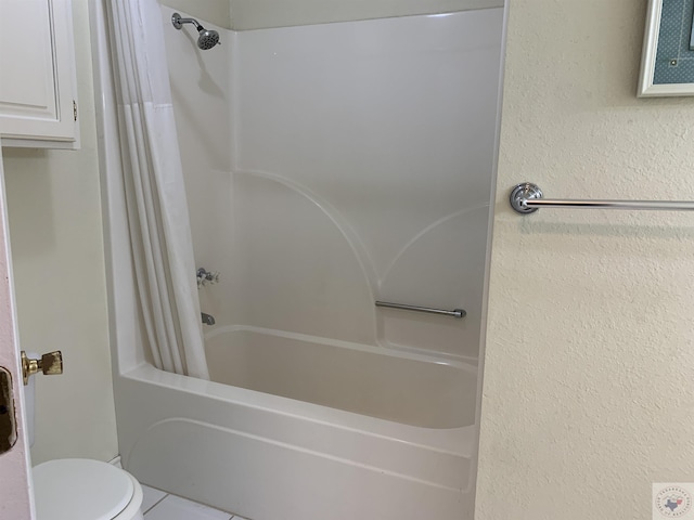 bathroom featuring shower / bathtub combination with curtain, toilet, and tile patterned flooring