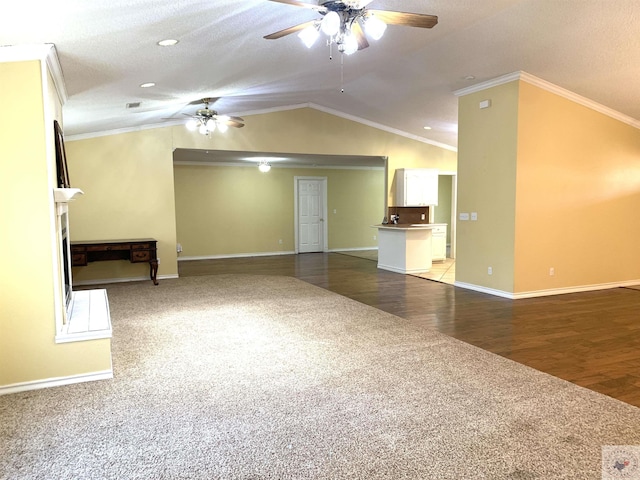 unfurnished living room featuring crown molding, ceiling fan, lofted ceiling, and carpet floors