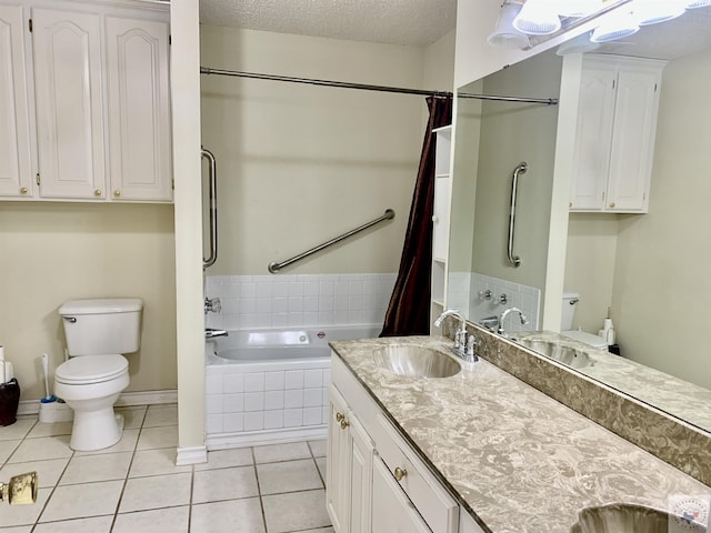 bathroom with tile patterned floors, tiled tub, toilet, and a textured ceiling