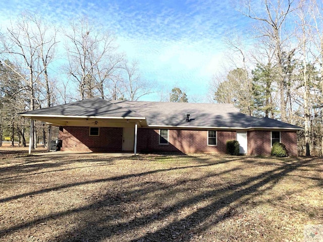 back of property featuring a lawn