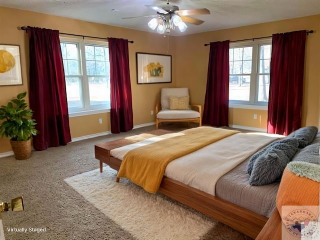 carpeted bedroom featuring baseboards and a ceiling fan