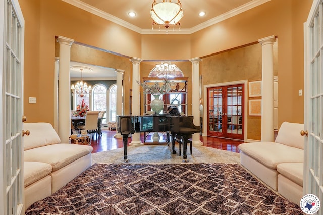 6632 Lakeridge Dr, Texarkana, TX 75503 - living room featuring a chandelier, ornate columns, french doors, wood finished floors, and ornamental molding