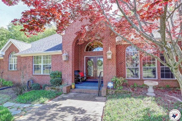 6632 Lakeridge Dr, Texarkana, TX 75503 - entrance to property with french doors, a shingled roof, and brick siding