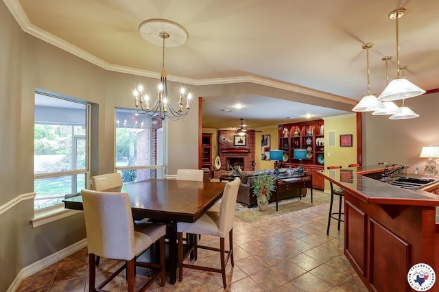 6632 Lakeridge Dr, Texarkana, TX 75503 - dining room with ornamental molding, a fireplace, a chandelier, ceiling fan, and baseboards