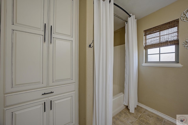 bathroom featuring shower / bath combination with curtain