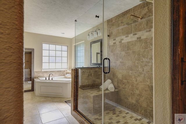 bathroom with independent shower and bath, a textured ceiling, and tile patterned flooring