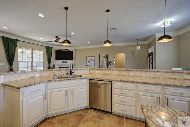 kitchen with decorative light fixtures, sink, light stone counters, stainless steel dishwasher, and crown molding