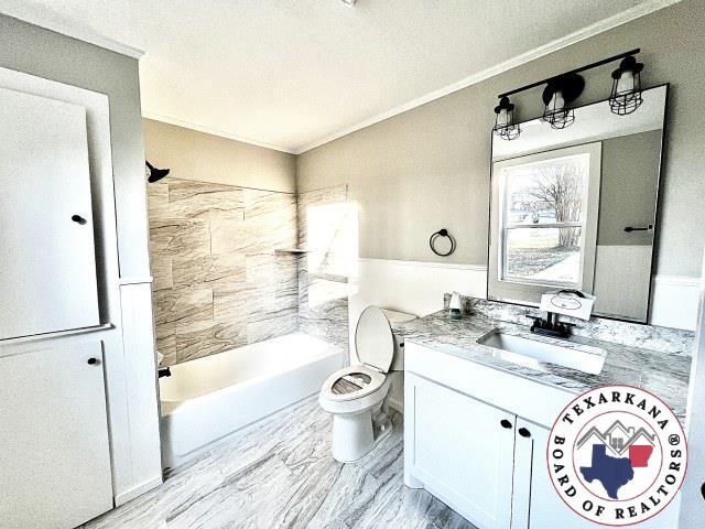 full bathroom with ornamental molding, toilet, shower / tub combination, and vanity