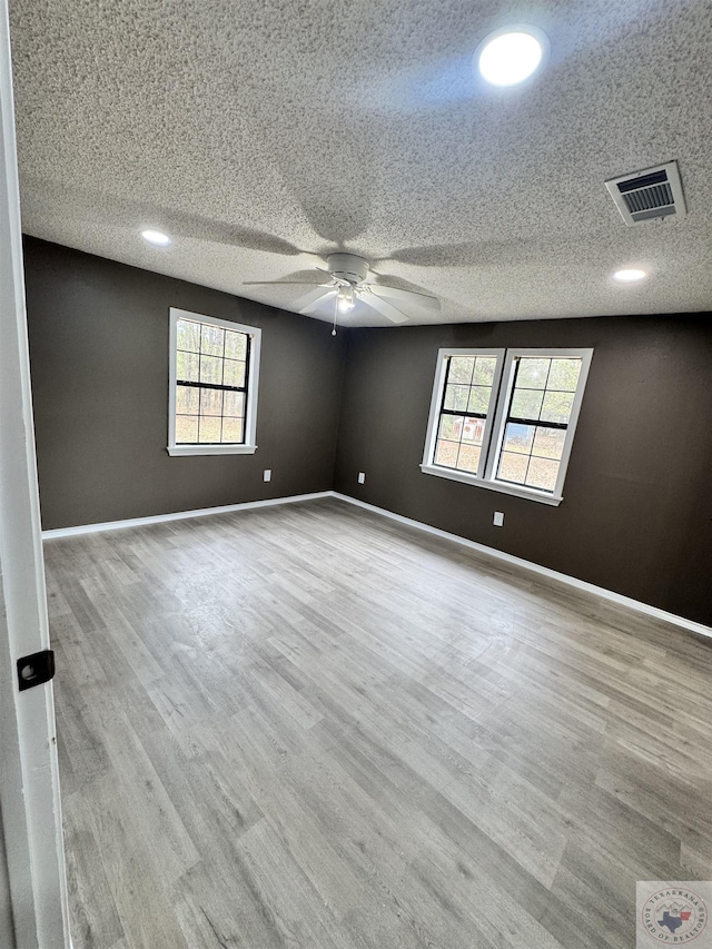 spare room with a textured ceiling and ceiling fan