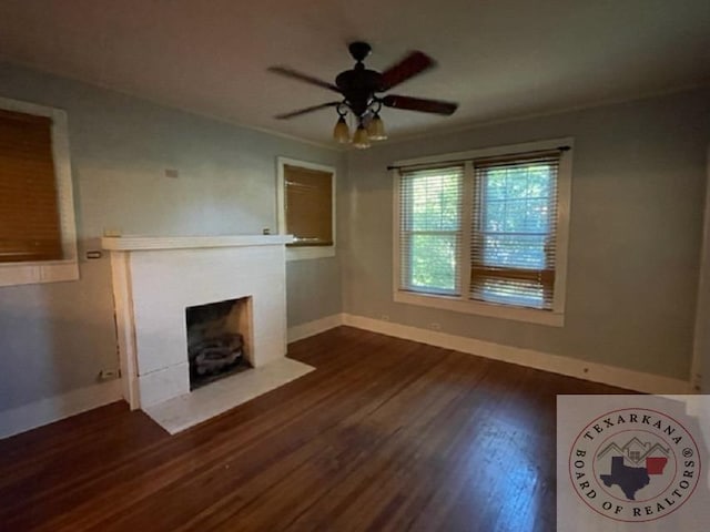 unfurnished living room featuring crown molding, ceiling fan, and dark hardwood / wood-style flooring